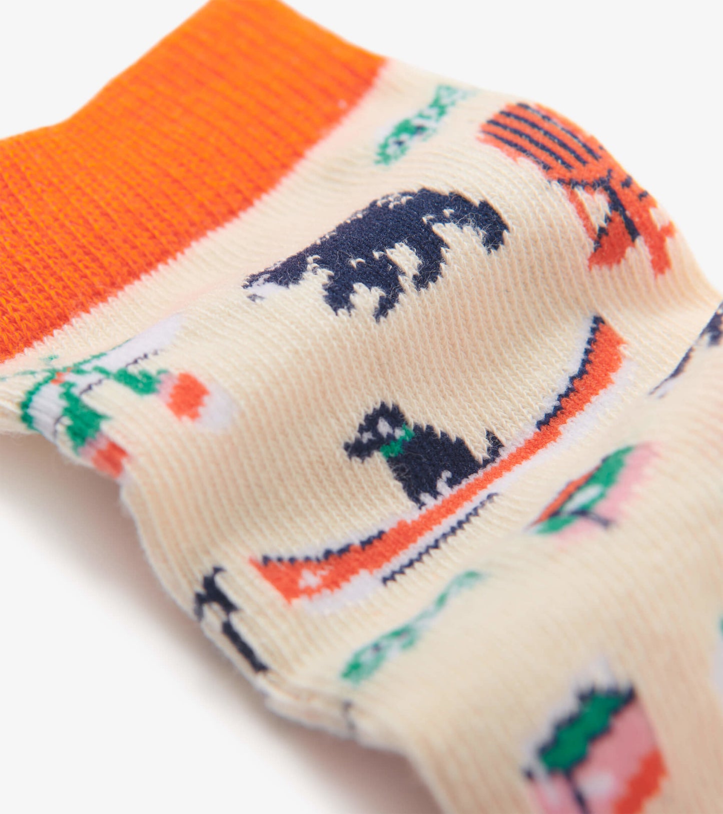 Cream socks with colorful lake-themed patterns, featuring bears, canoes, and trees, with an orange ribbed cuff.