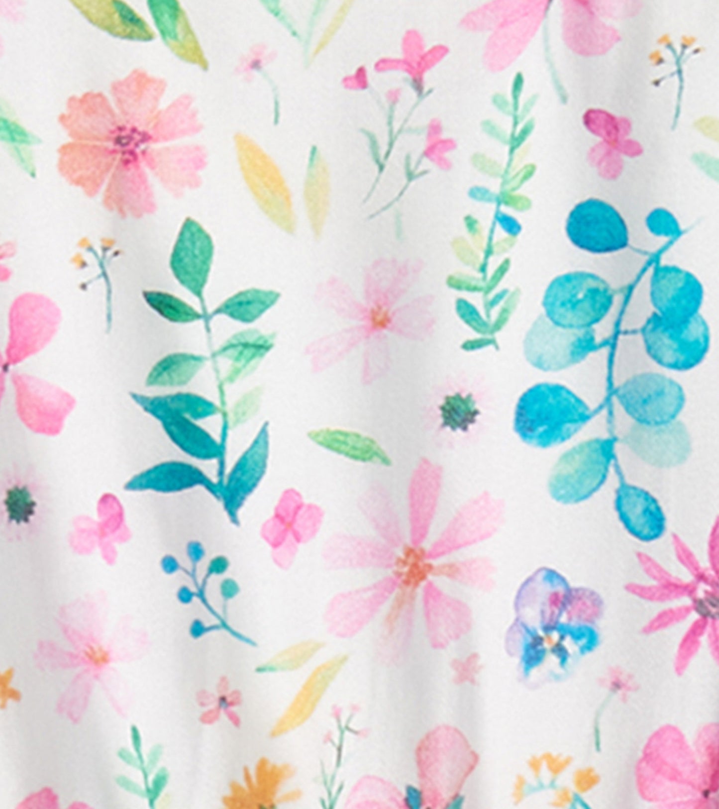 White dress featuring a colorful pressed flower and leaf pattern in pink, blue, and green hues.