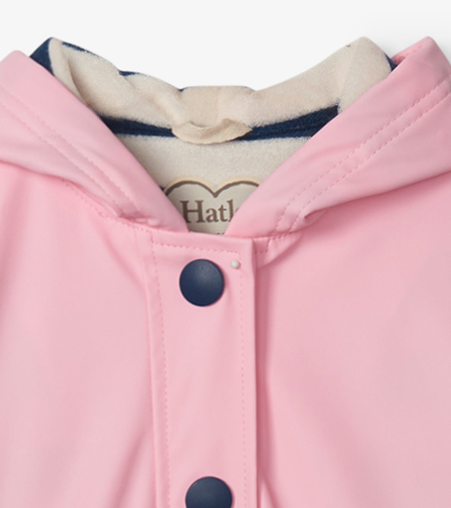 Pink rain jacket with navy buttons and hood, featuring a smooth, waterproof exterior.