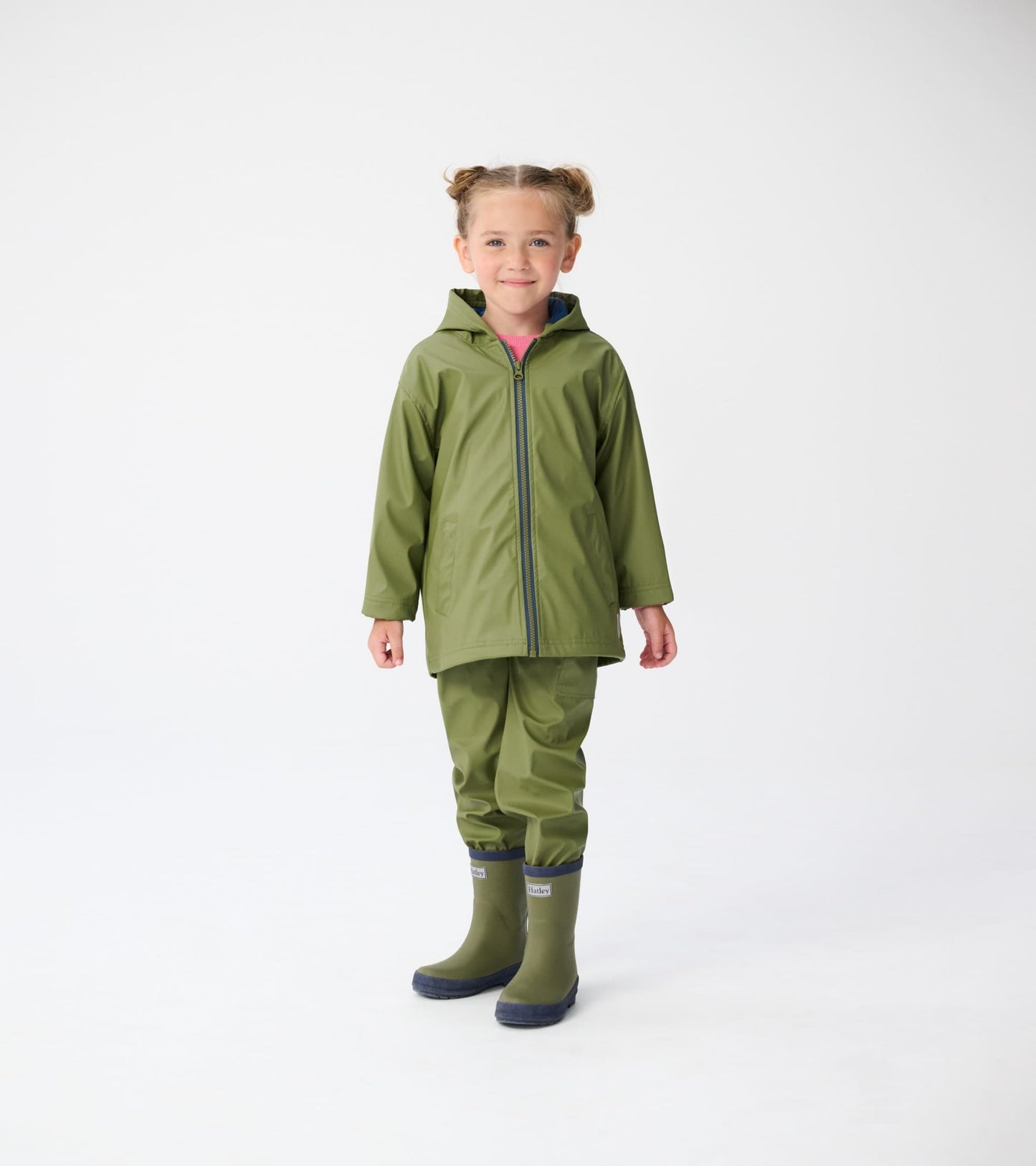 Forest green zip-up rain jacket with a hood, worn by a child, paired with matching rain pants and boots.