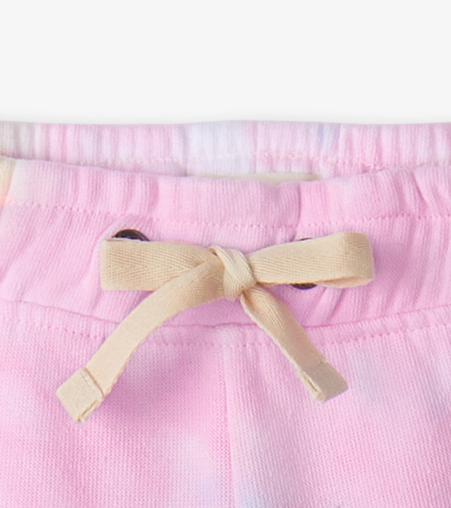 Light pink pull-on shorts with a drawstring waist, featuring a soft fabric and a casual design suitable for summer wear.