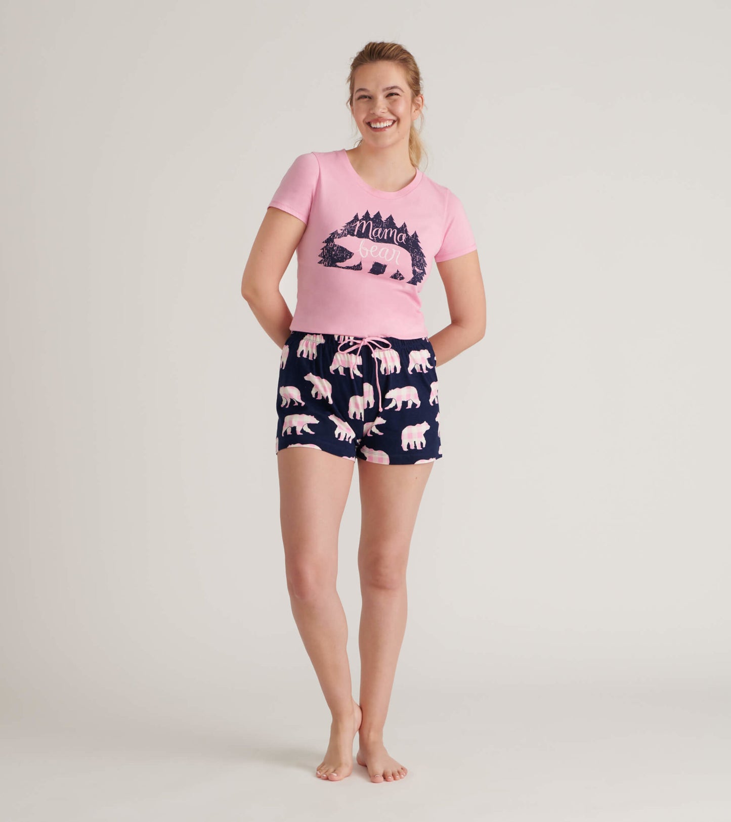 Pink short-sleeve pajama t-shirt with "Mama Bear" graphic, paired with navy shorts featuring pink bear prints.