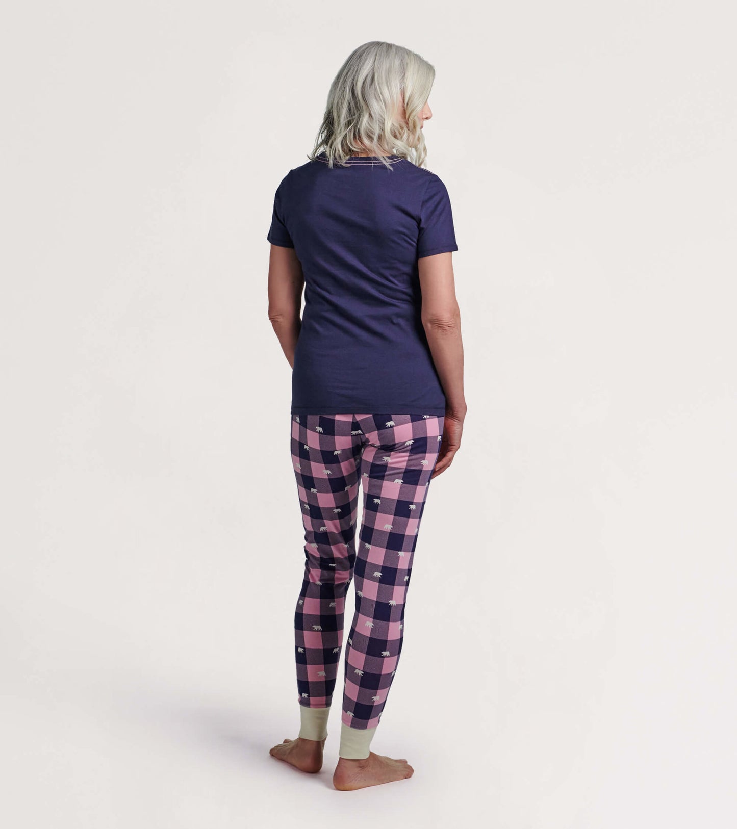 Navy short-sleeve pajama t-shirt paired with pink and navy checkered pajama pants featuring bear prints, viewed from the bac…