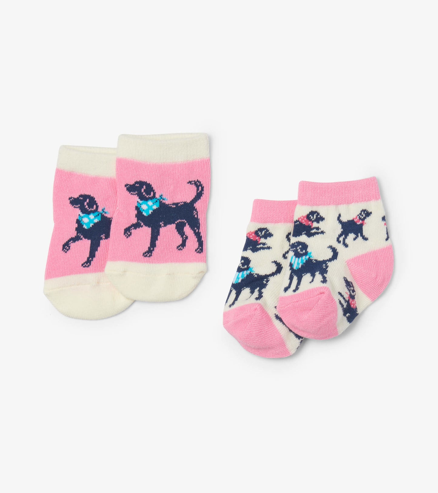 Two pairs of baby socks featuring playful dog designs, one pink with a single dog and one cream with multiple dogs.