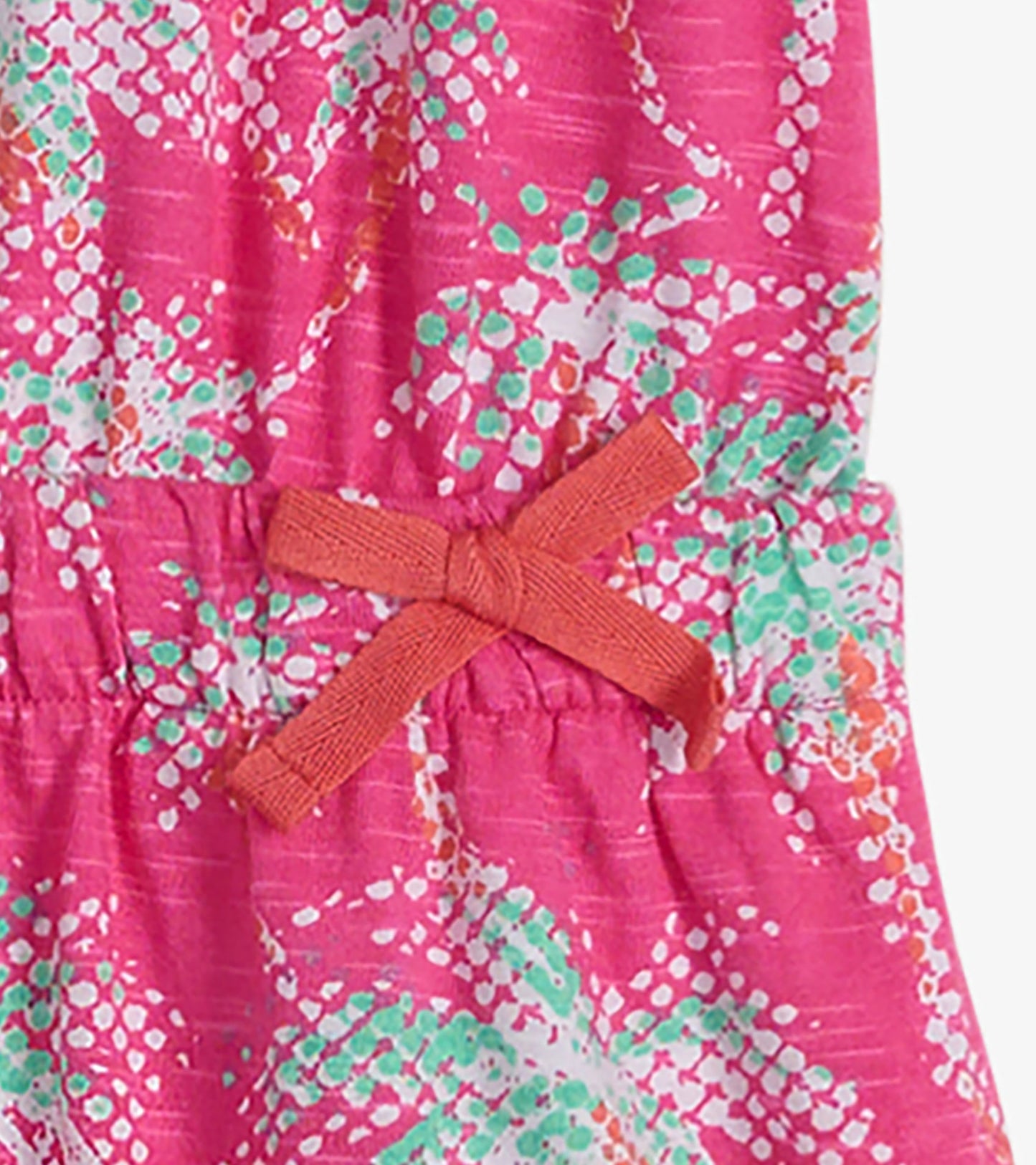 Pink t-shirt dress featuring a palm tree pattern and an elastic waist with a bow detail. Suitable for casual wear.