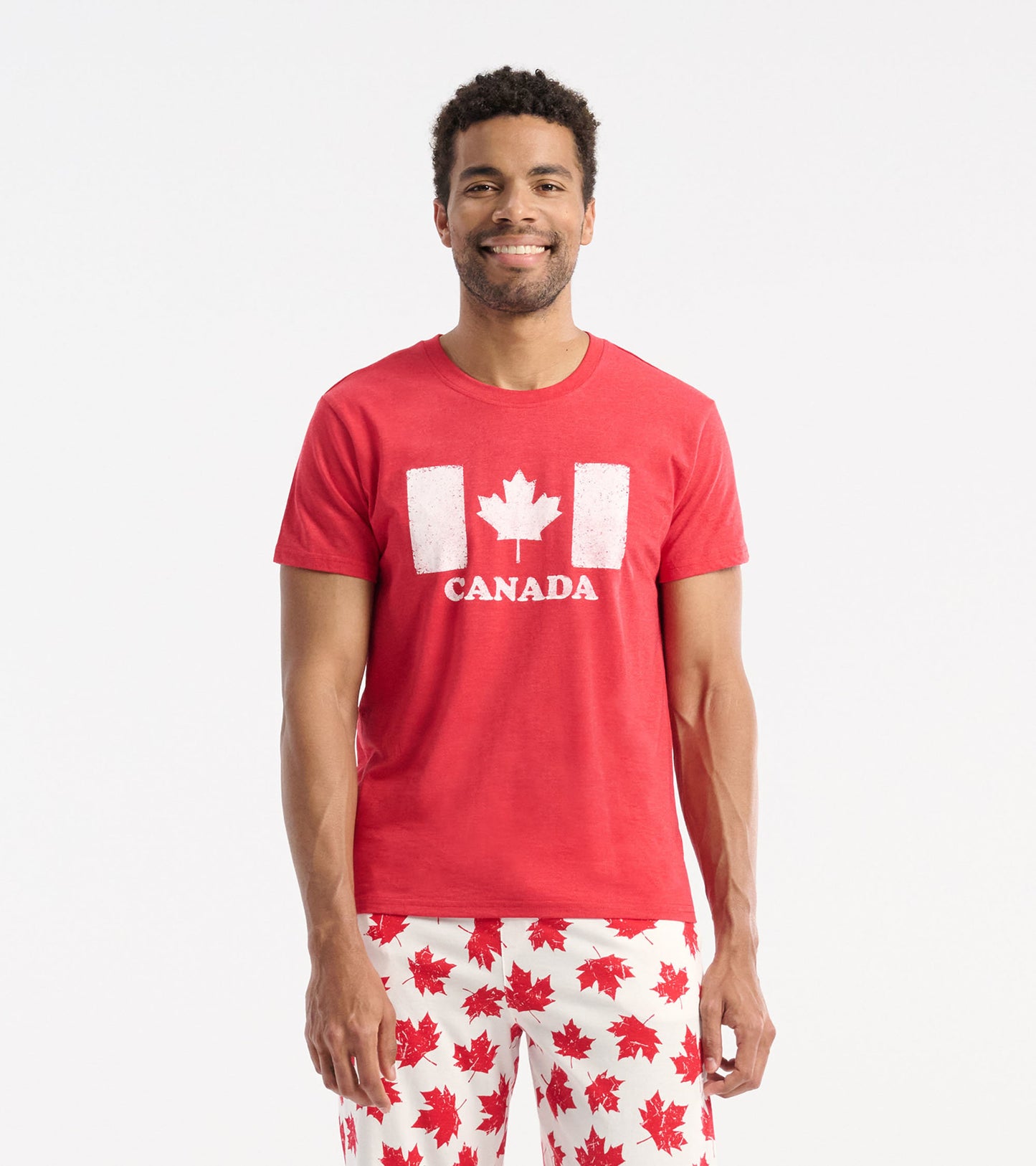 Red cotton t-shirt featuring a white maple leaf and "CANADA" graphic on the front, worn by a smiling man.