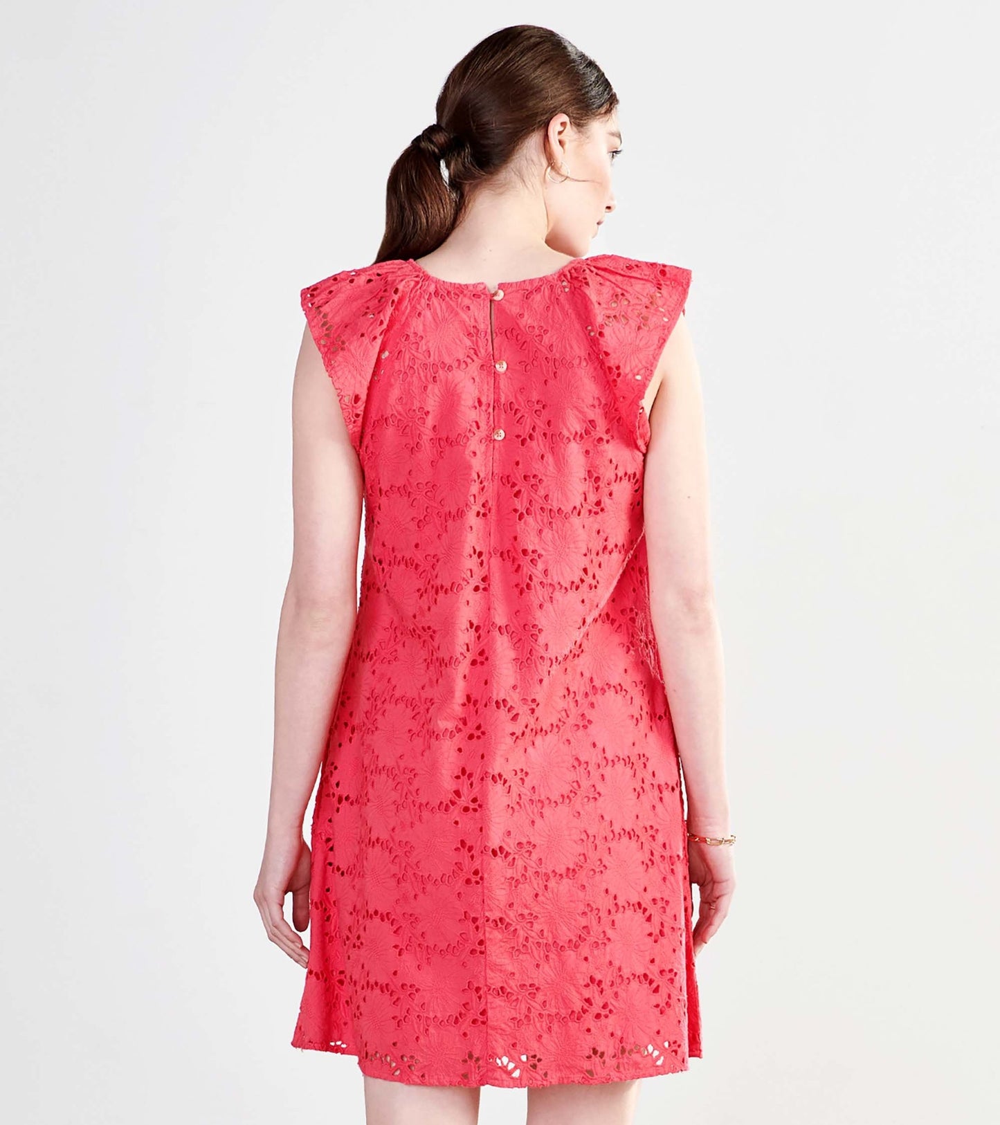 Rouge red eyelet dress with cap sleeves and a button closure at the back, showcasing a floral pattern.