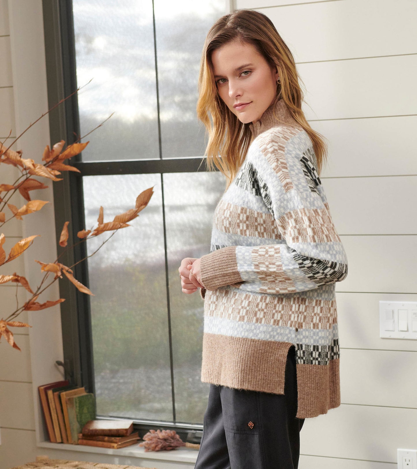Mock neck sweater featuring a celestial plaid pattern in soft beige, blue, and black tones, with side slits for comfort.