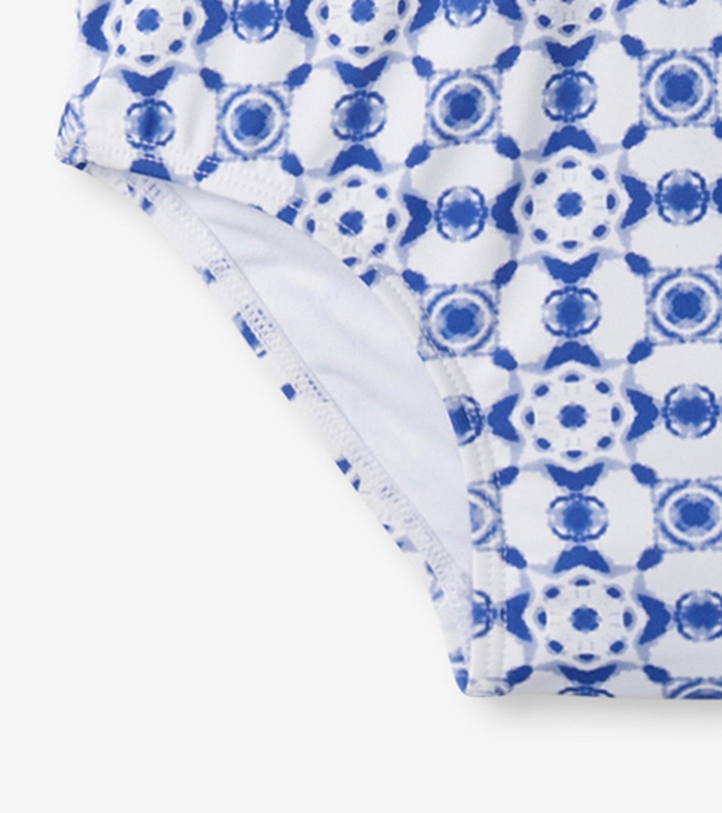 Blue and white kaleidoscope patterned one-piece rashguard with a snug fit, ideal for swimming and sun protection.