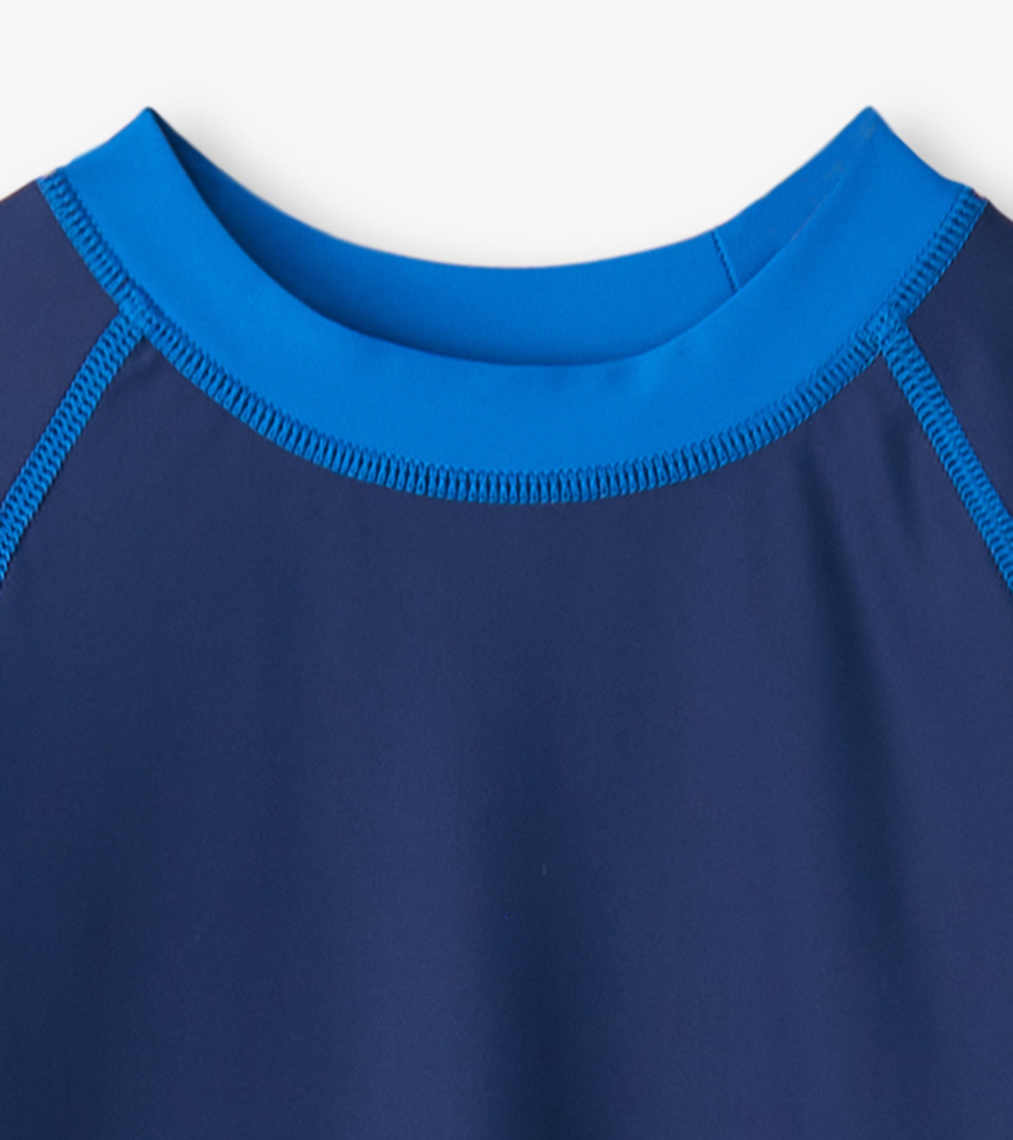 Navy long sleeve rashguard with a bright blue collar and contrasting stitching, designed for boys' water activities.