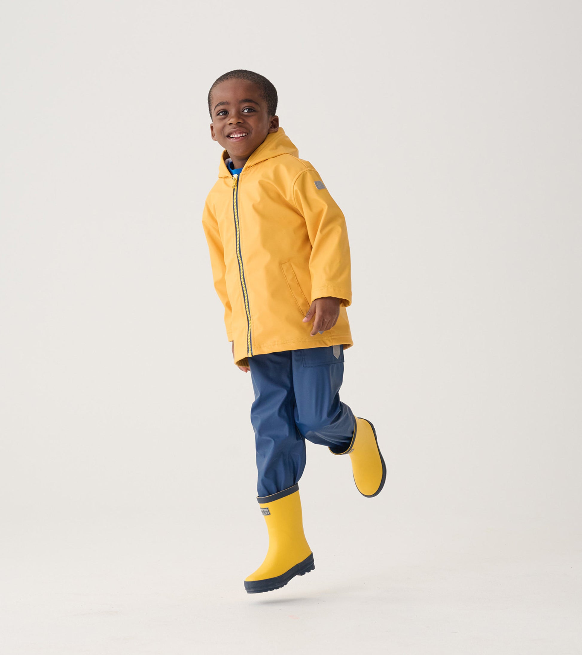 Navy waterproof rain pants for kids, featuring a relaxed fit, perfect for outdoor play in wet weather.