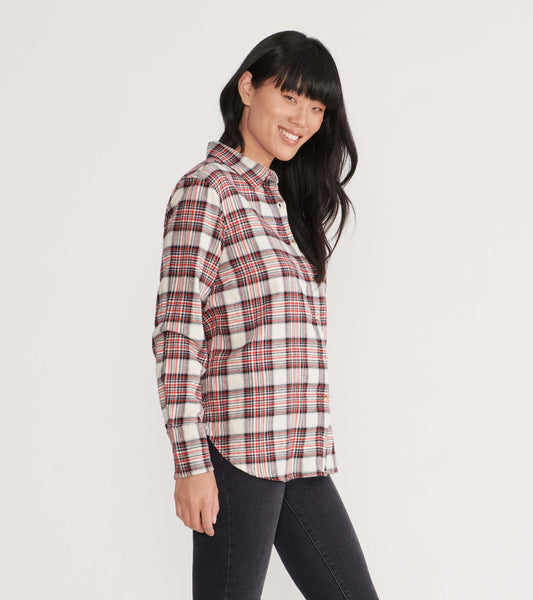 Cream plaid flannel shirt with red and black accents, featuring a button-up front and long sleeves, worn by a smiling model.