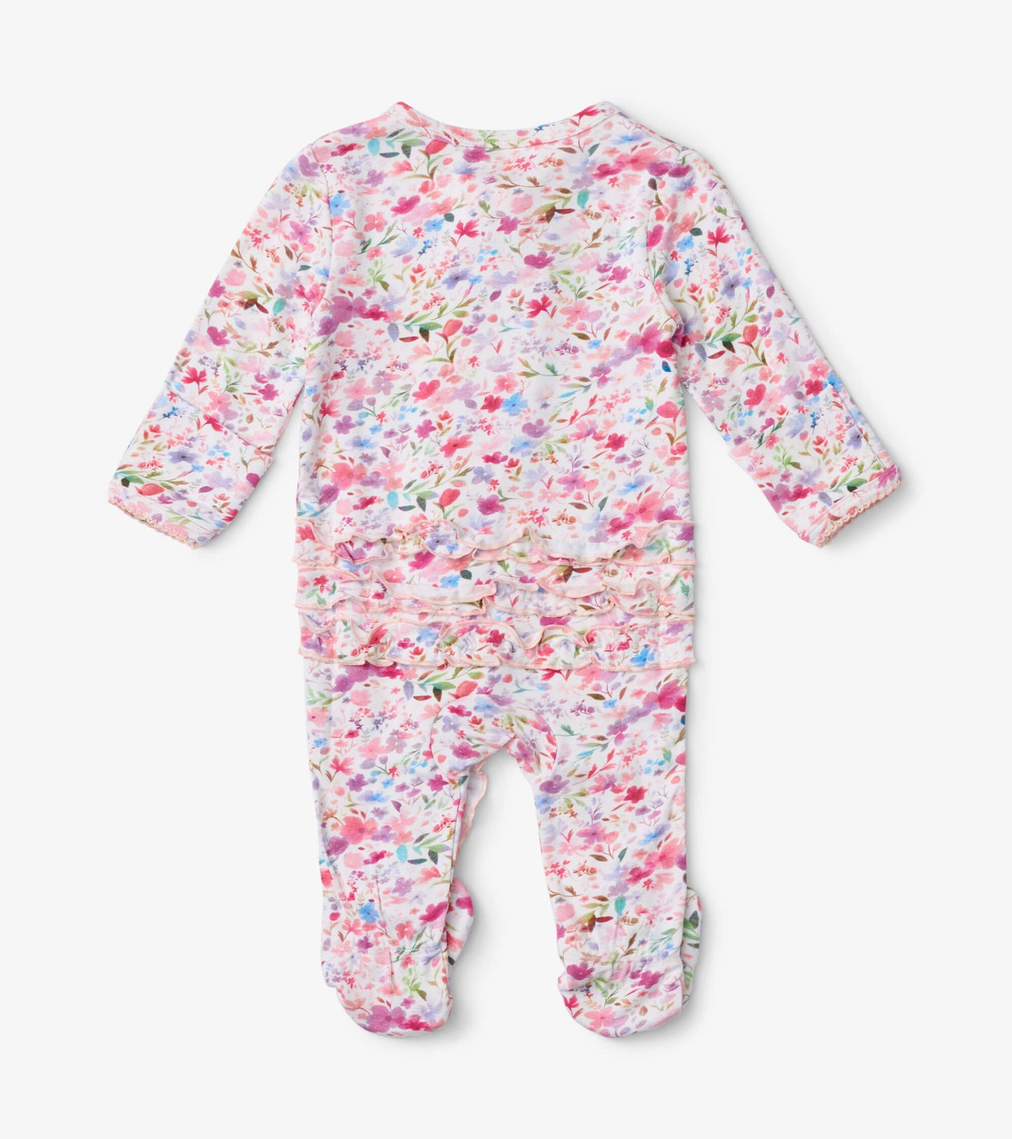 Baby footed sleeper featuring a colorful watercolor floral pattern with ruffle detailing at the back.