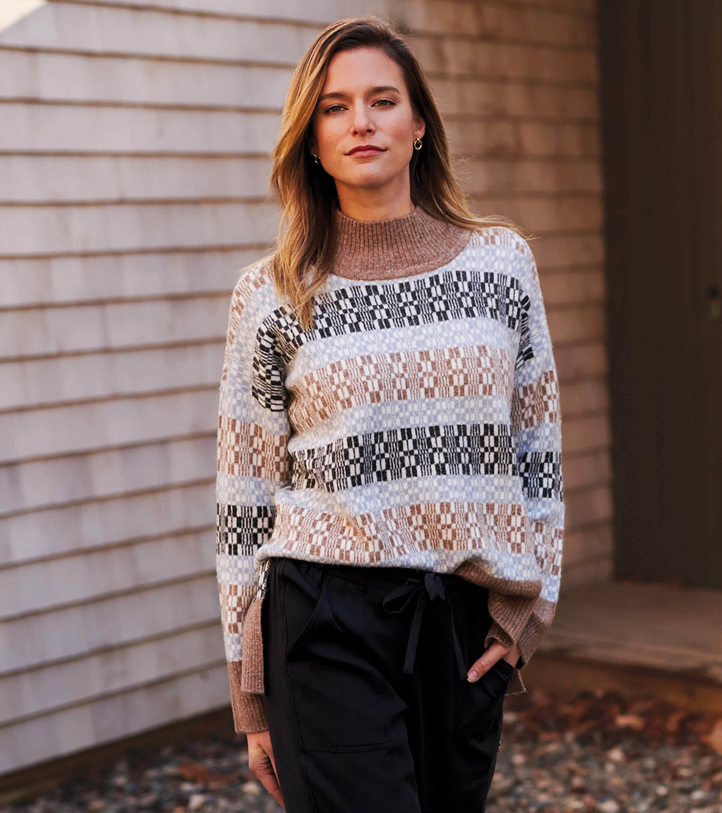 Mock neck sweater featuring a celestial plaid pattern in earthy tones, with a relaxed fit and long sleeves.