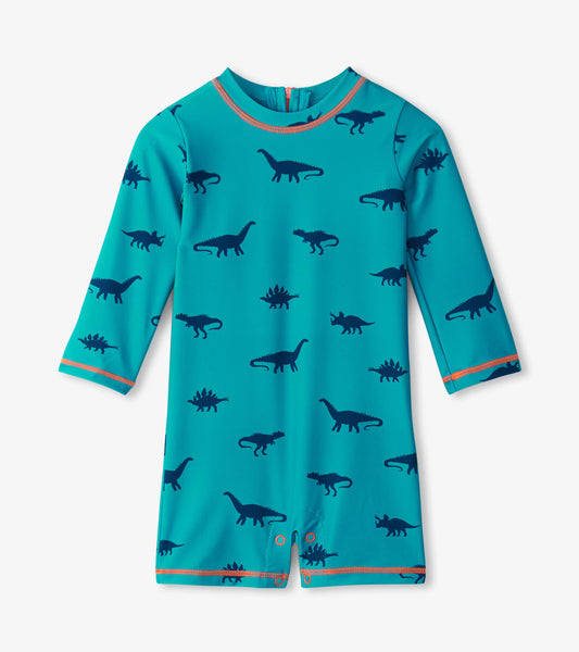 Turquoise one-piece rashguard with navy dinosaur silhouettes and orange trim, suitable for baby boys.