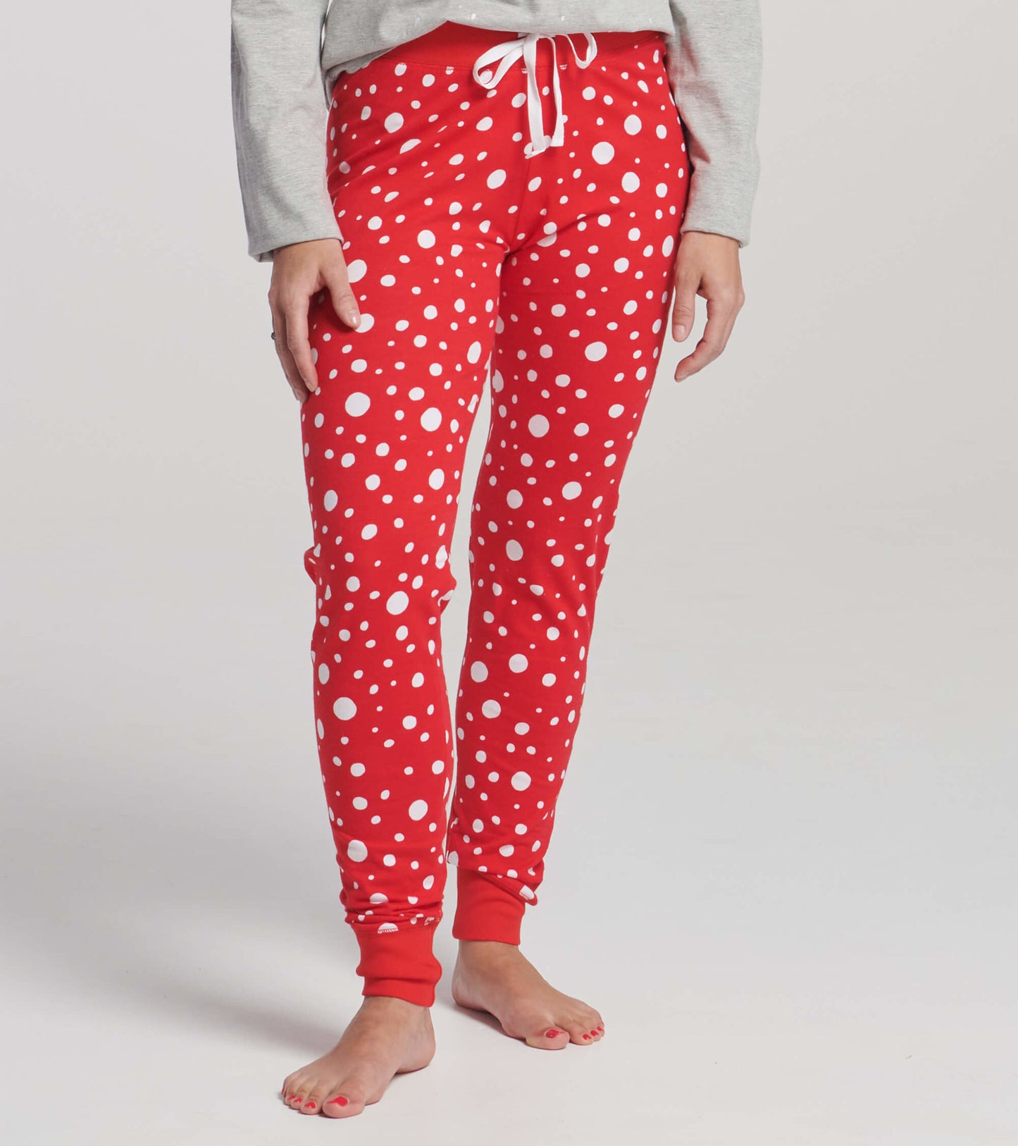 Red sleep leggings featuring a playful white polka dot pattern, with a drawstring waist and fitted cuffs.