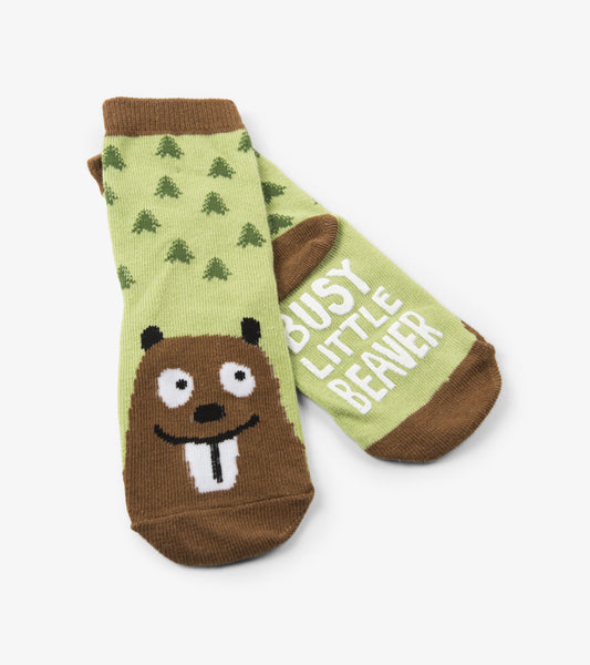 Green socks featuring a beaver graphic and trees, suitable for kids ages 2-7.