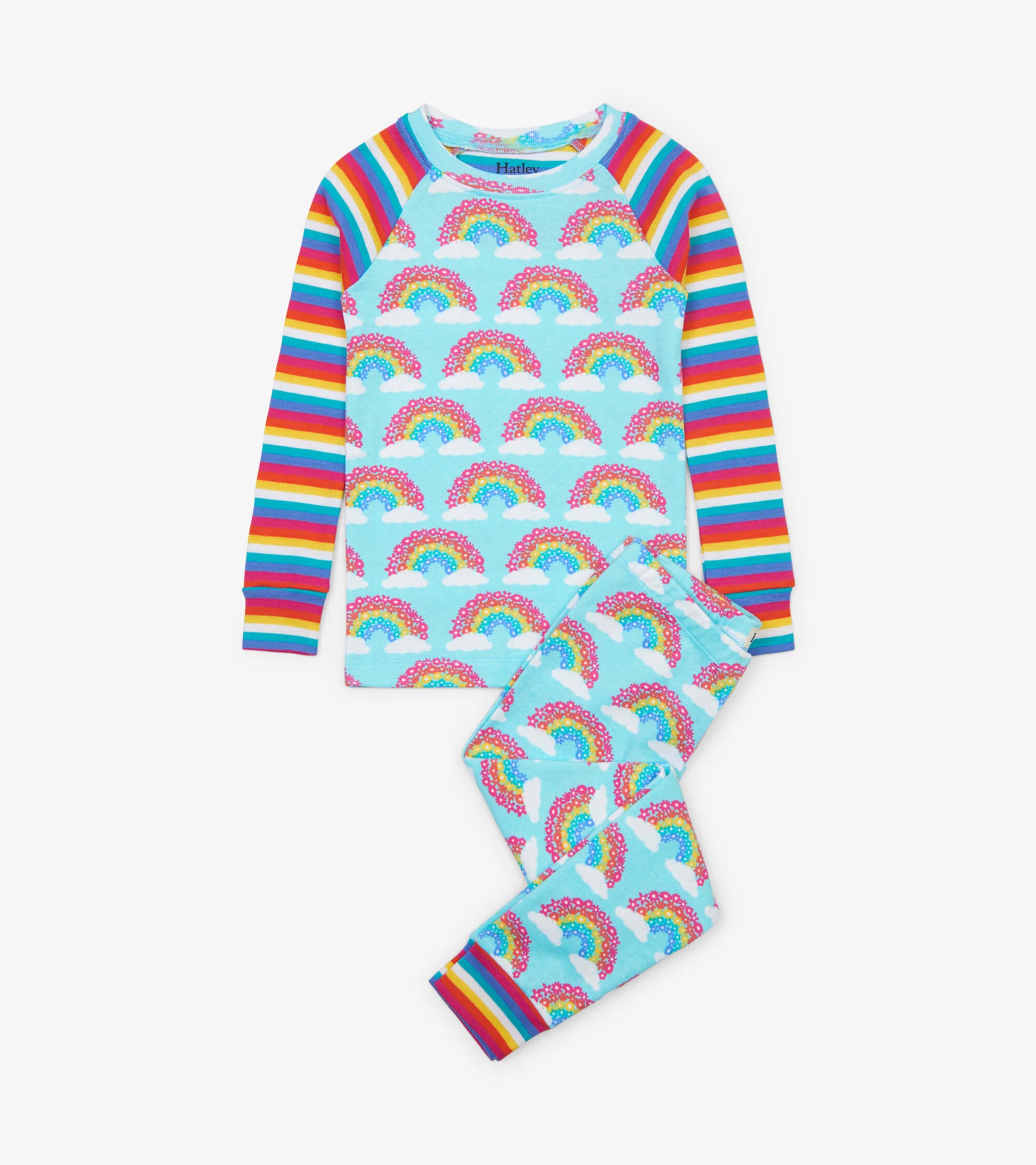 Light blue organic cotton pajama set featuring rainbow and cloud patterns with multicolored striped sleeves and cuffs.
