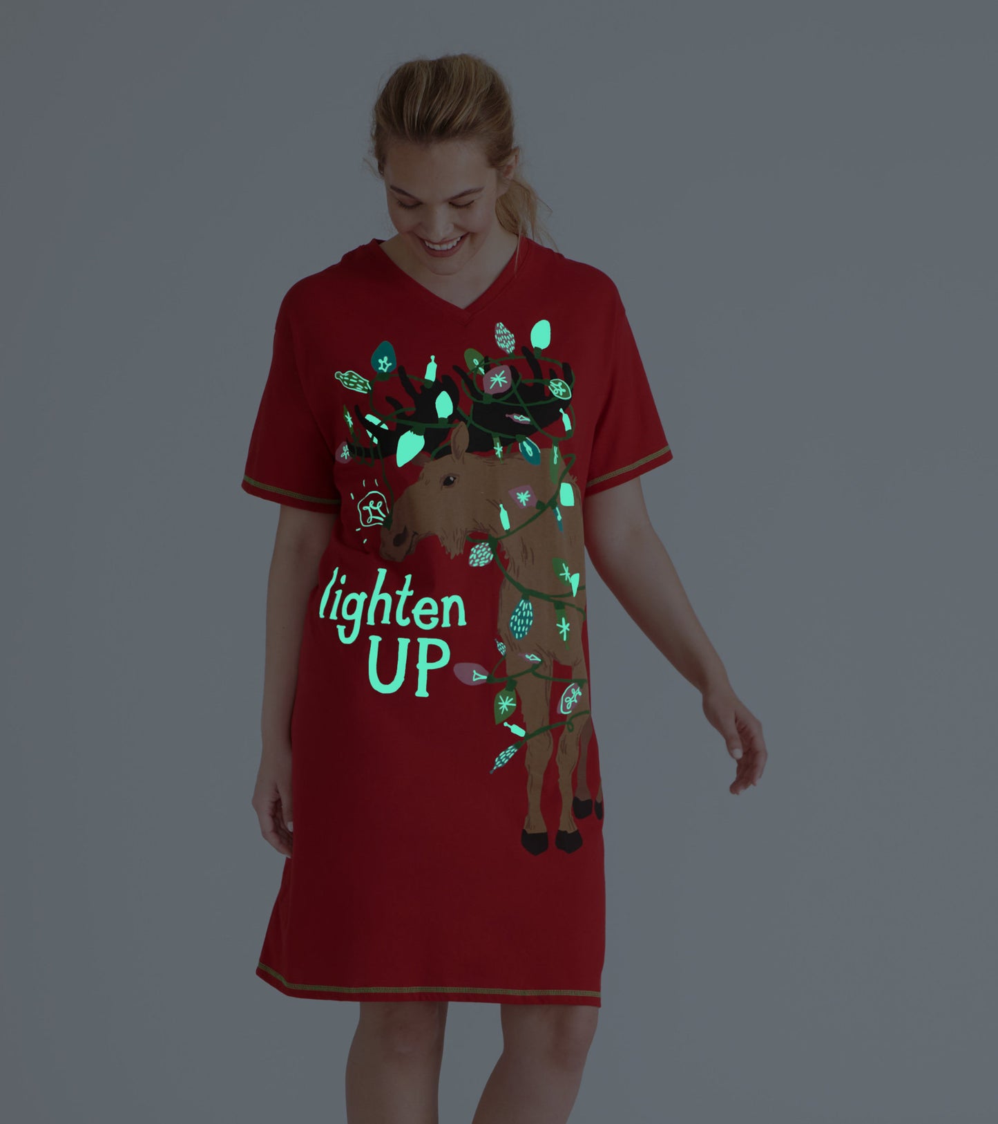 Red glow-in-the-dark sleepshirt featuring a moose design with holiday lights and the phrase "lighten UP.