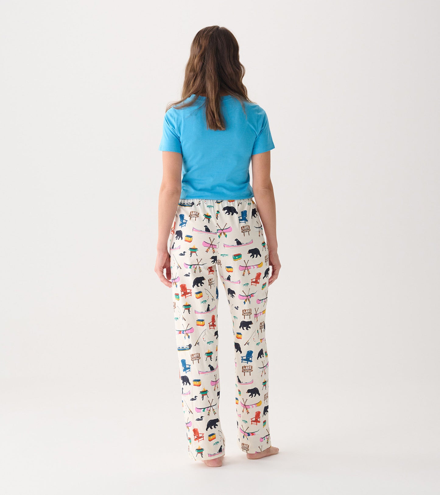Women's cotton pajama pants in cream with colorful outdoor-themed patterns, featuring a relaxed fit and elastic waistband.