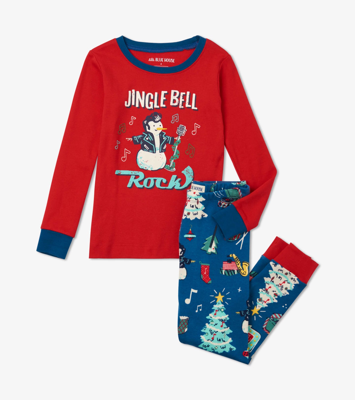 Red long-sleeve top with festive graphic and blue pajama pants featuring Christmas tree and musical notes pattern.