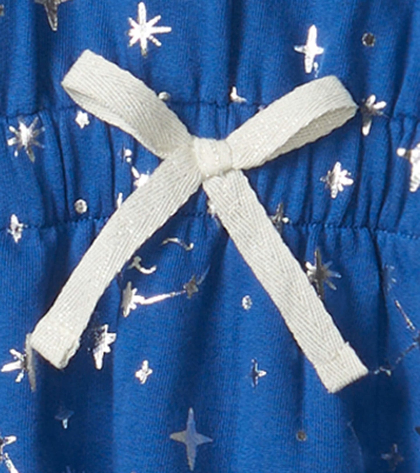 Blue terry dress featuring silver star patterns and a light-colored bow at the waist.