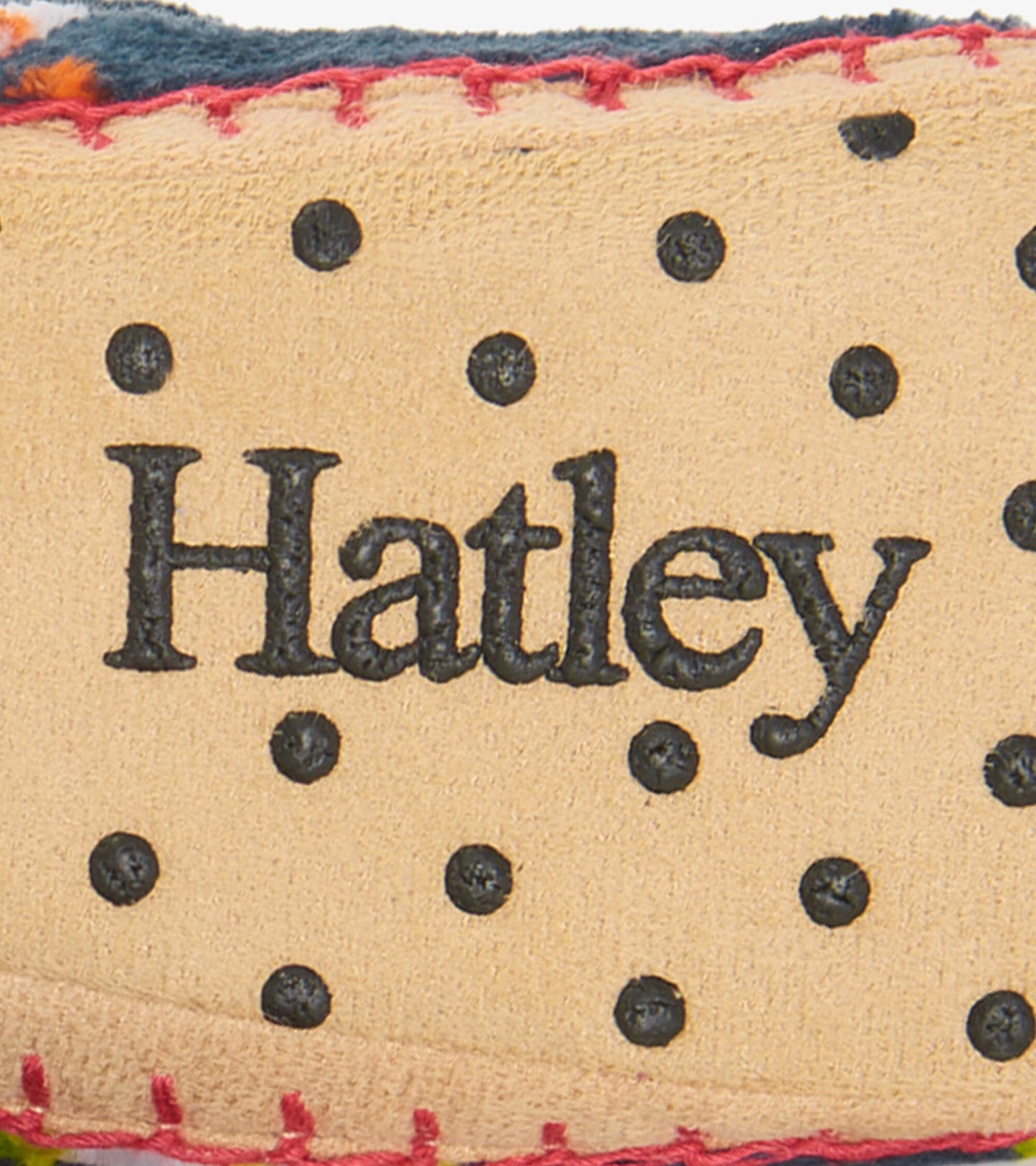 Fleece slippers with a colorful rocket pattern, featuring a soft interior and durable sole, ideal for kids.