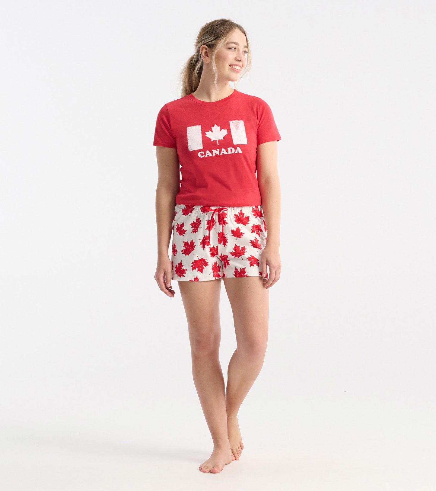 Red and white cotton sleep shorts featuring a maple leaf pattern, designed for comfort and relaxation.