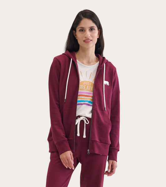 Maroon full zip hoodie with a bear logo, featuring a drawstring hood and front pockets, worn over a graphic tee.
