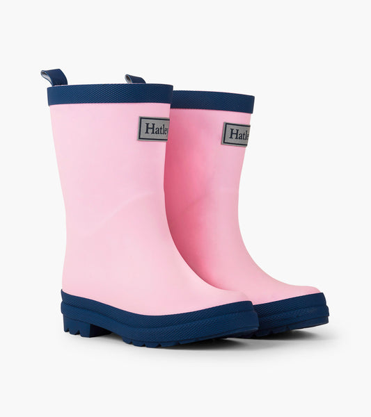 Pink and navy matte rain boots with a textured sole and pull tabs for easy wear. Ideal for kids.