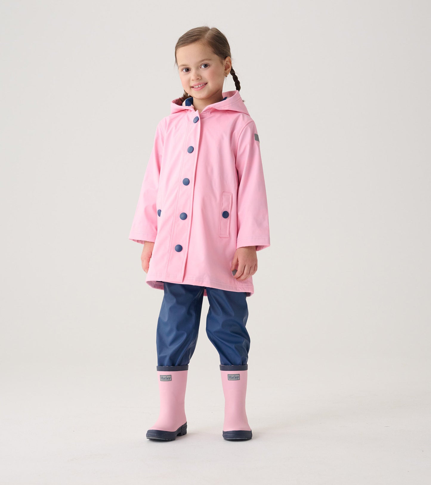 Kids' pink matte rain boots with navy accents, designed for wet weather, featuring a sturdy sole and a comfortable fit.