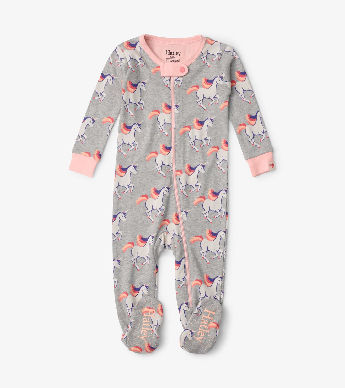 Gray footed sleeper with unicorn print, pink accents, and zipper closure, suitable for infants.