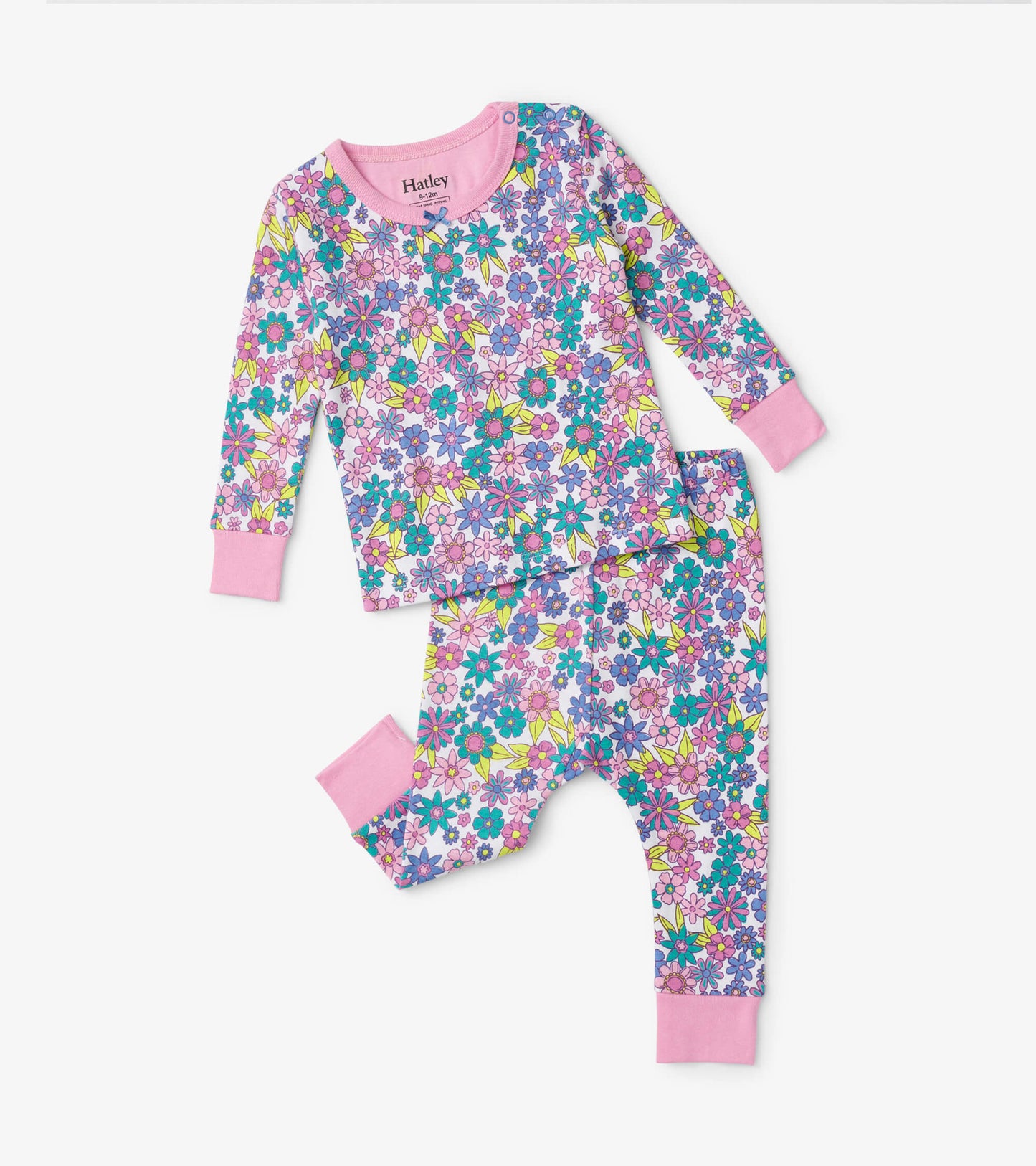 Colorful floral baby pajama set featuring long sleeves and pants with pink cuffs, made from soft fabric.