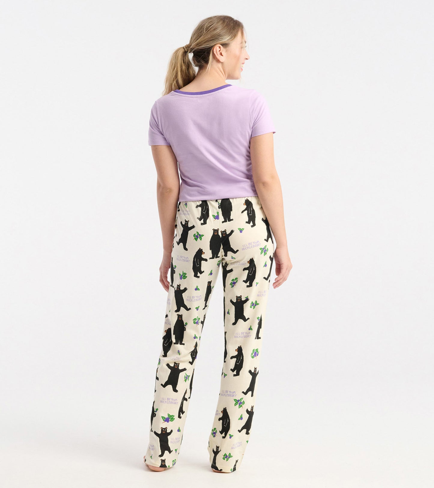 Light purple short-sleeve pajama t-shirt paired with cream pants featuring black bears and green accents.