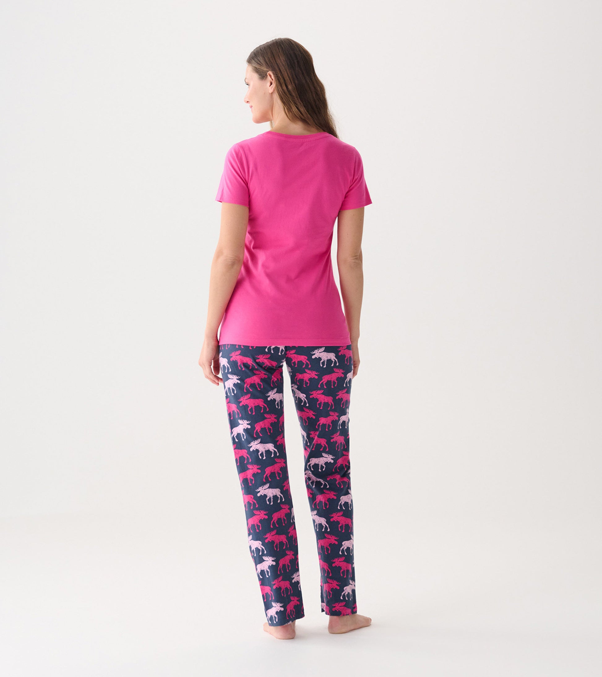 Pink short-sleeve pajama t-shirt paired with navy pants featuring a moose pattern in pink and white.
