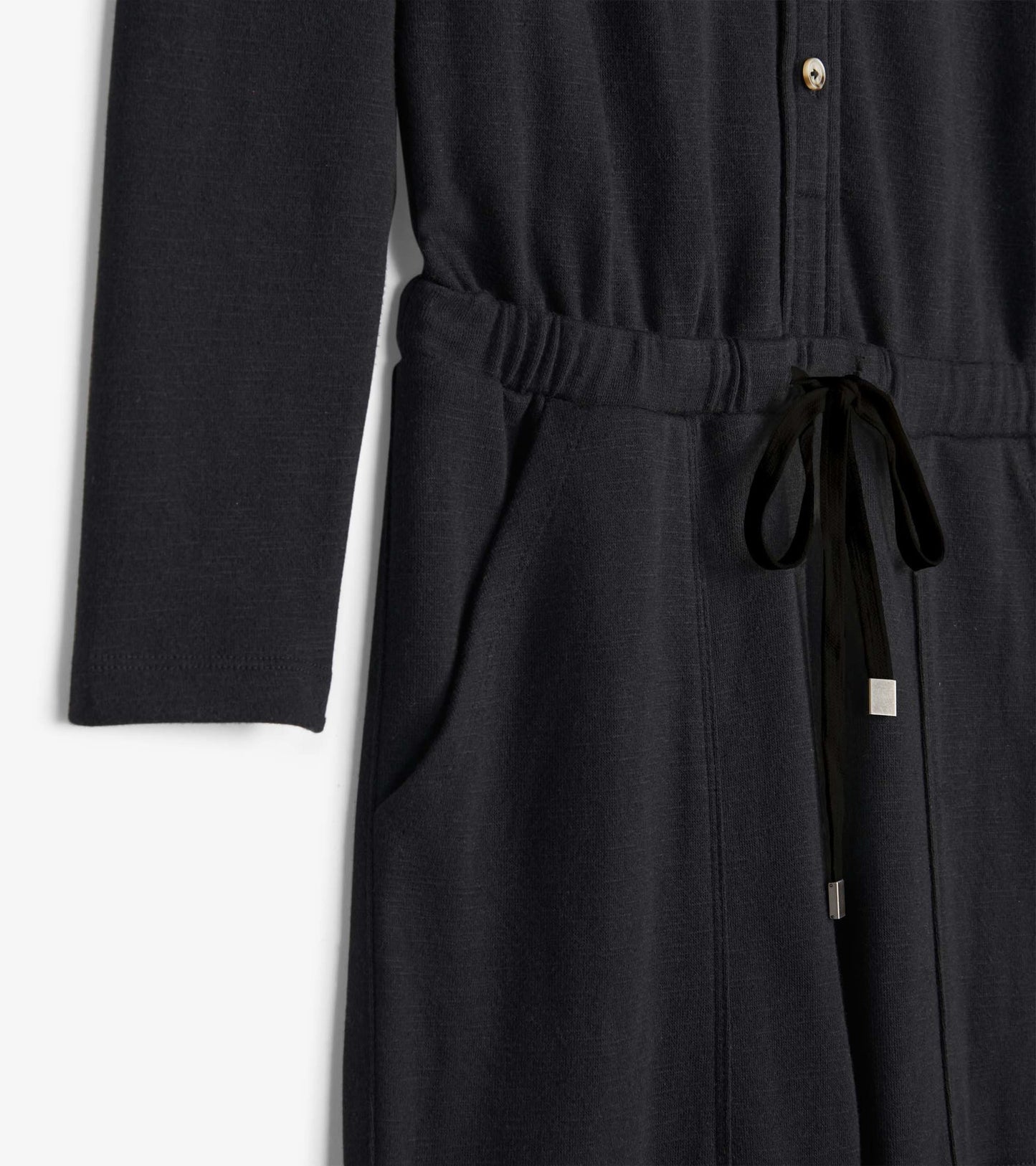 Black long-sleeve jumpsuit with a button front, elastic waist, and drawstring tie, featuring side pockets.