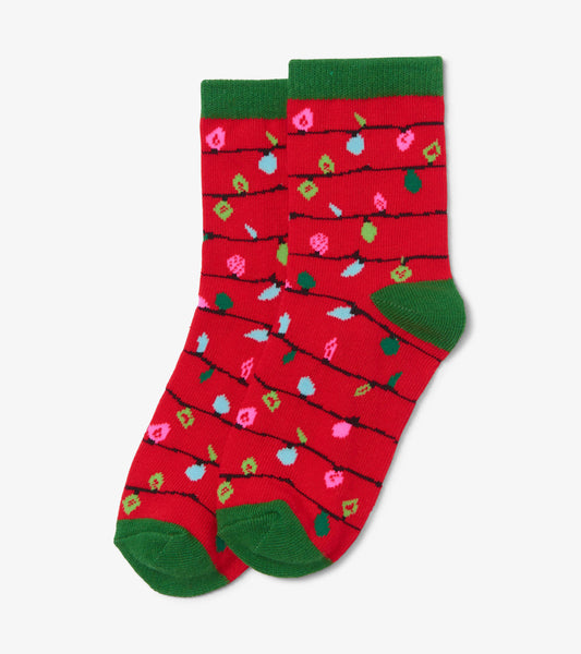 Red crew socks featuring a festive pattern of colorful lights and green cuffs, suitable for kids ages 2-7.