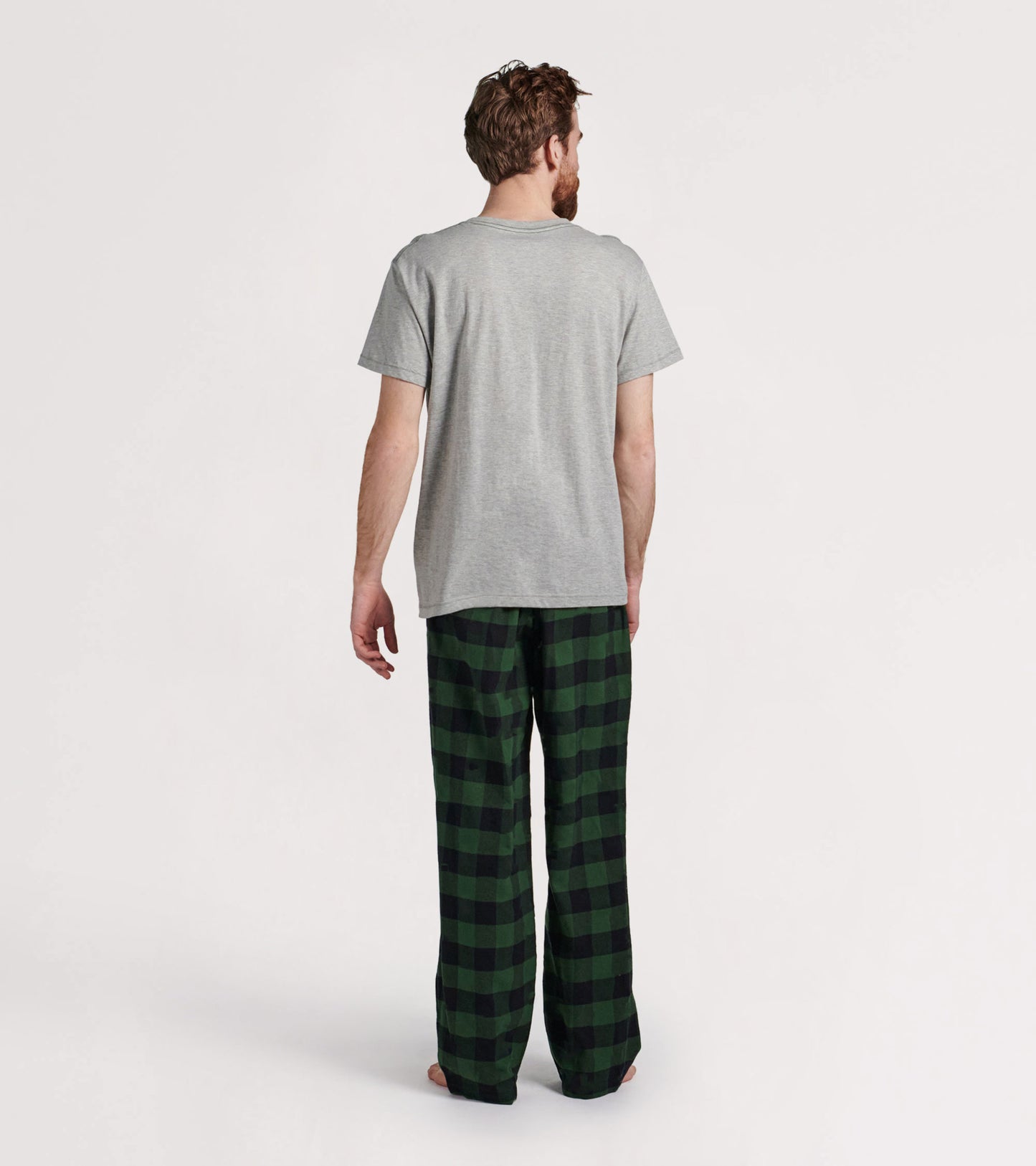 Forest green plaid flannel pajama pants with a relaxed fit, shown on a model from the back.