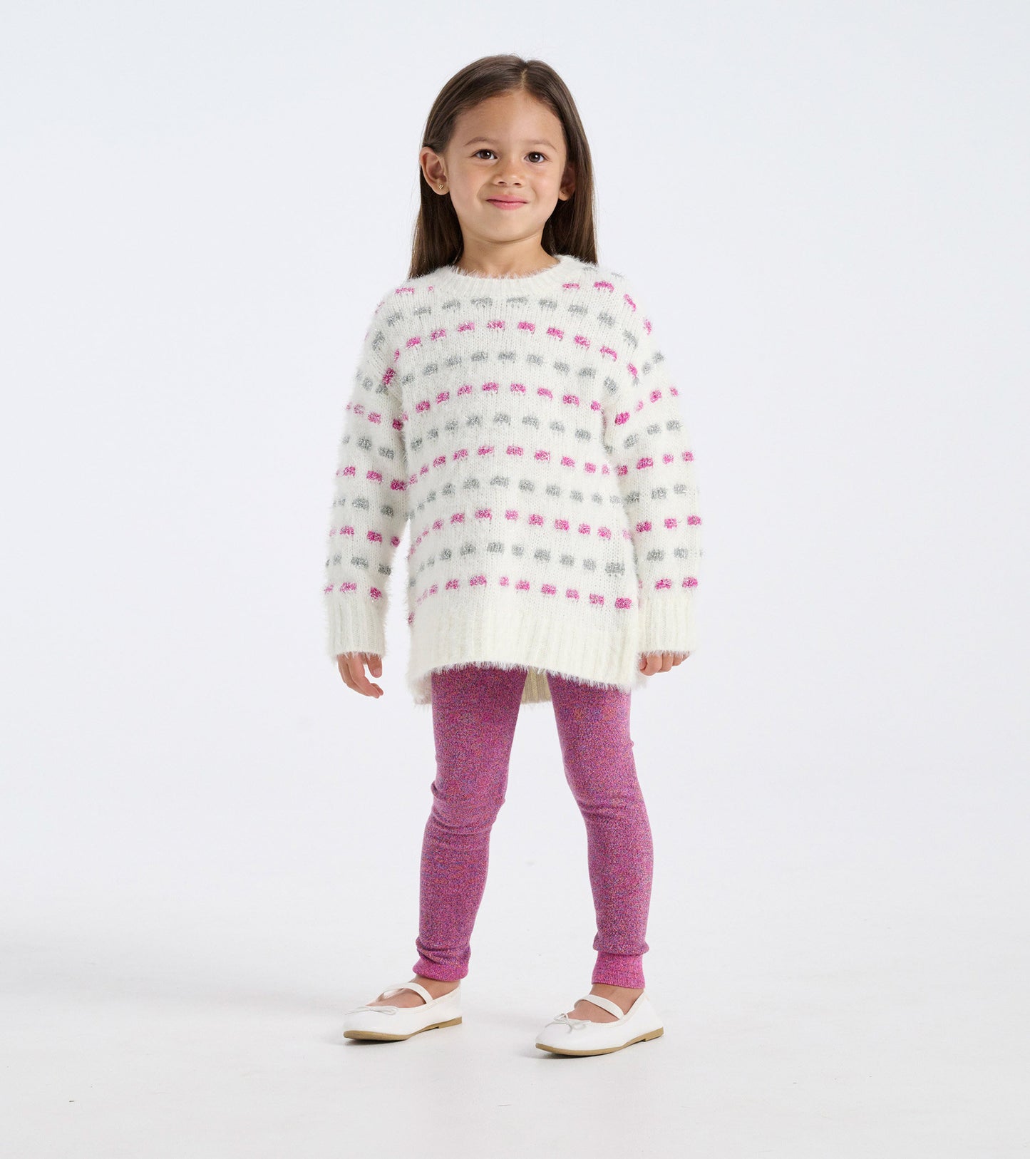 White sweater tunic with pink and gray stripes, paired with pink leggings and white shoes, worn by a young girl.