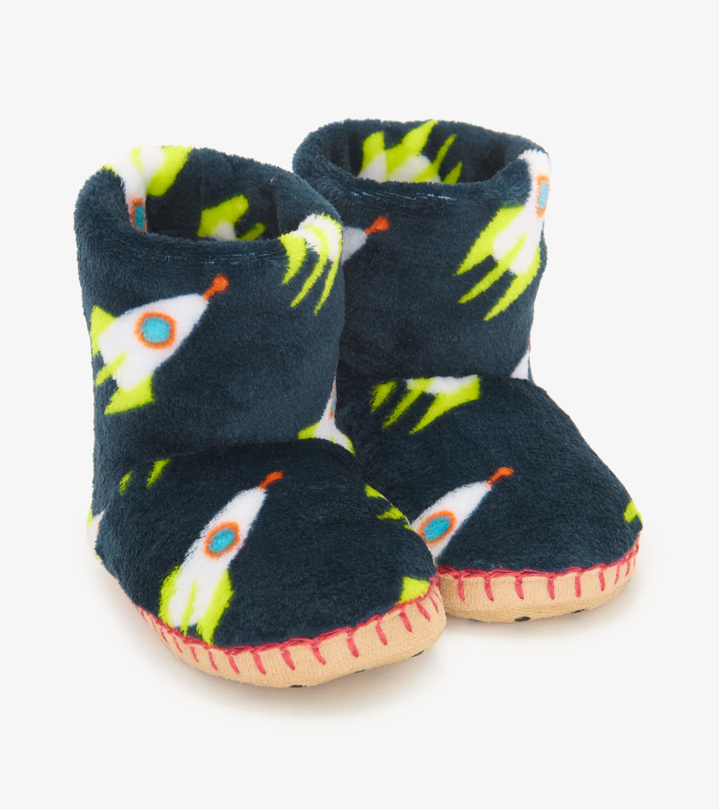 Navy fleece slippers featuring rocket patterns, with a soft interior and contrasting red stitching on the sole.
