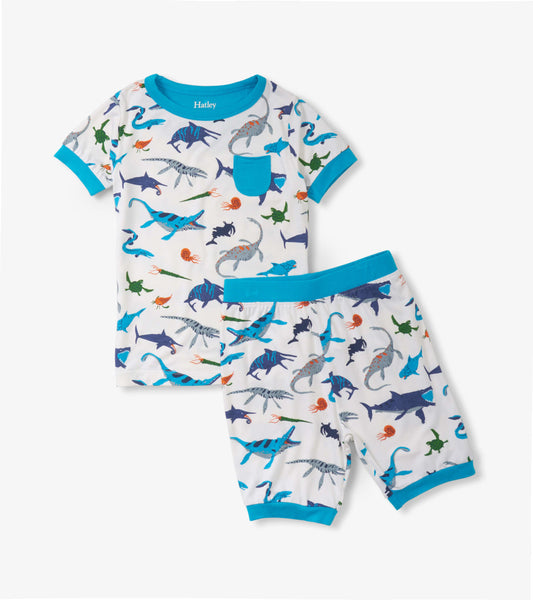 Short pajama set featuring a white base with colorful prehistoric marine animal prints and blue trim.