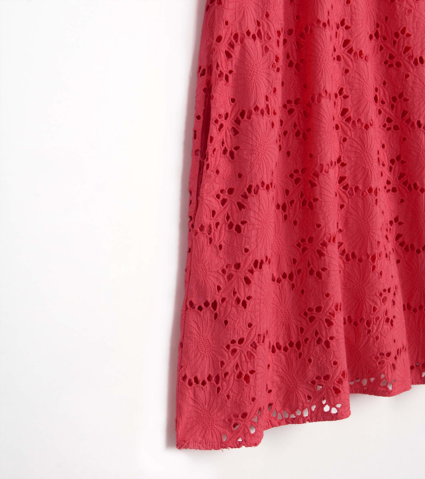 Rouge red eyelet dress featuring floral patterns and a lightweight fabric, ideal for warm weather occasions.