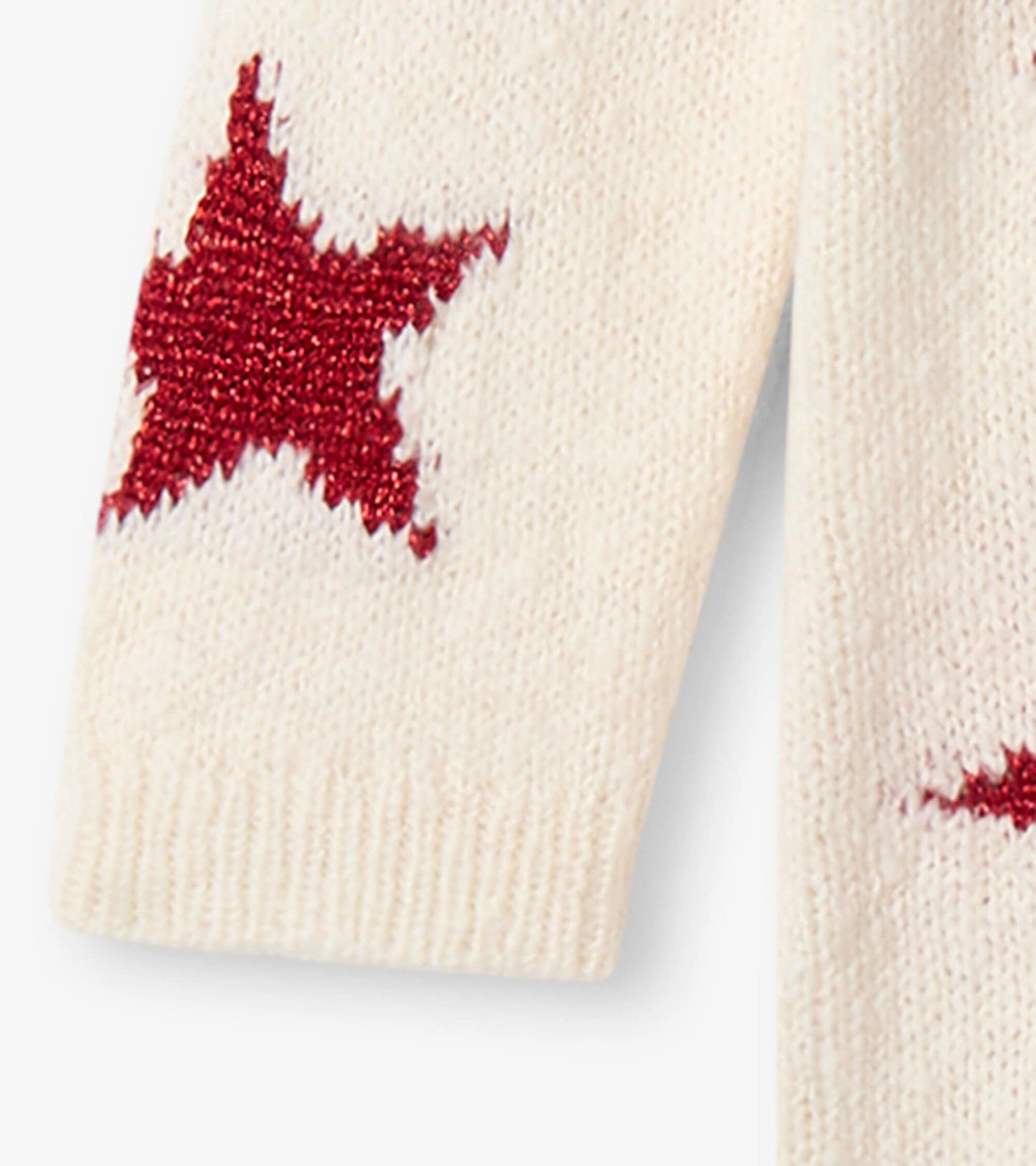Cream sweater dress featuring red star patterns, perfect for festive occasions. Soft knit fabric for comfort.