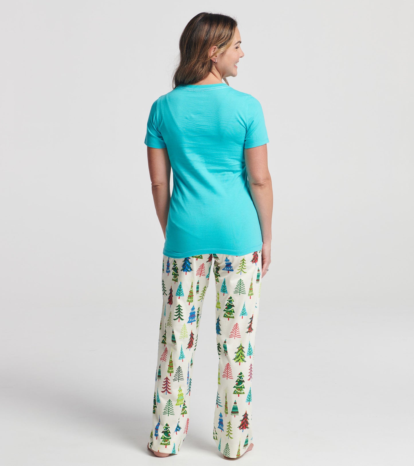 Aqua short sleeve t-shirt worn with festive tree-patterned pants, viewed from the back.