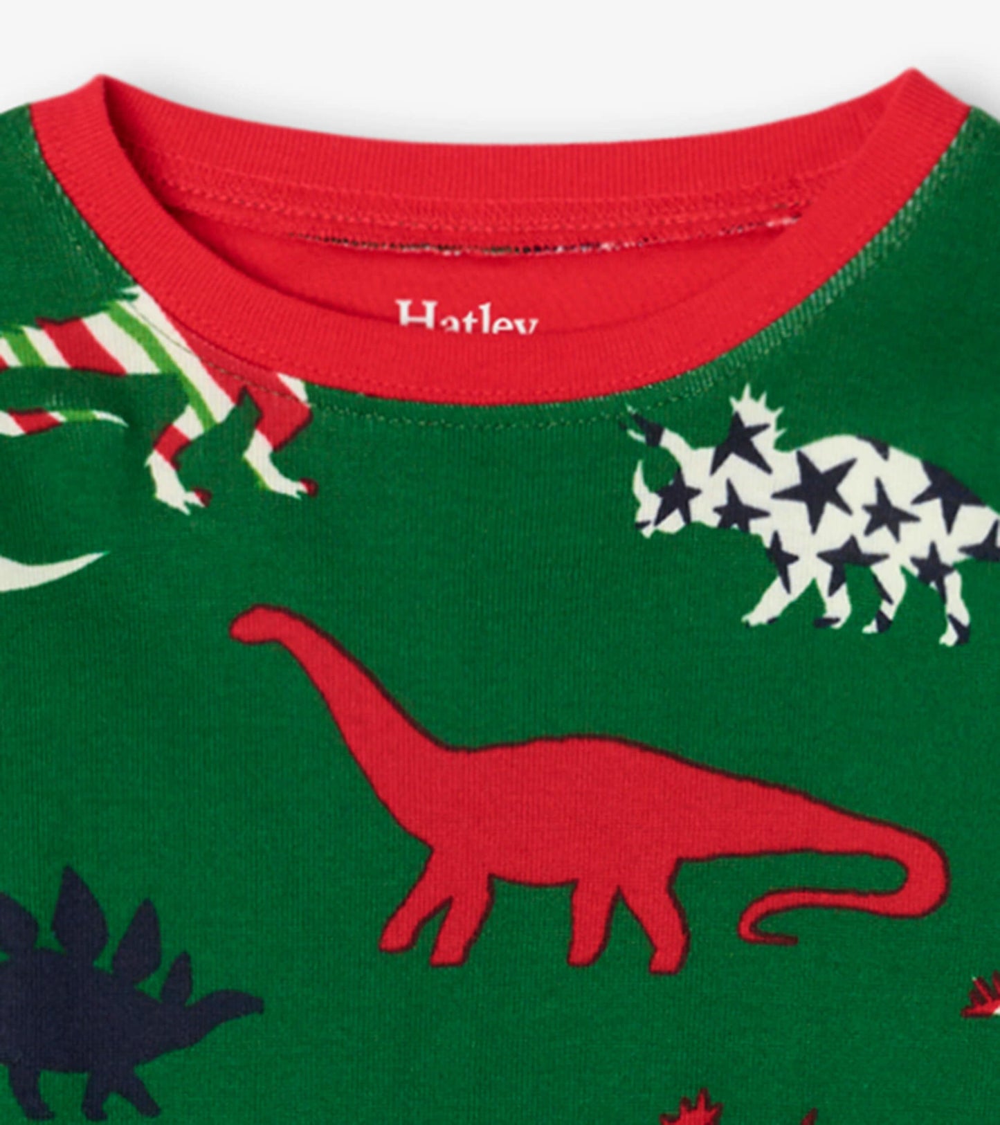 Green organic cotton pajama set featuring colorful dinosaur patterns and a red collar, designed for kids.