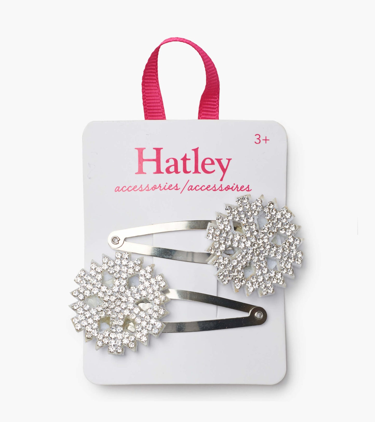 Silver snowflake snap clips adorned with sparkling rhinestones on a card with a pink hanging loop.