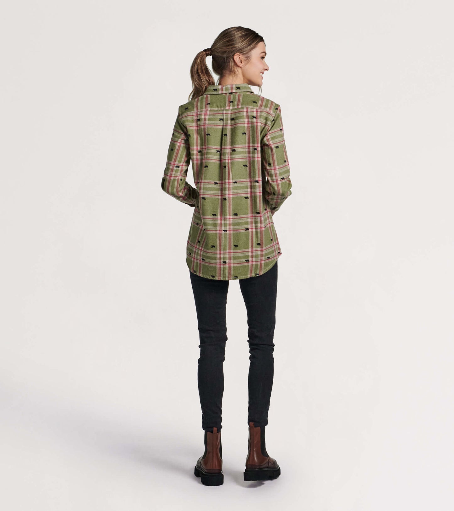 Green flannel shirt with a plaid pattern and bear motifs, shown from the back, paired with black jeans and brown boots.