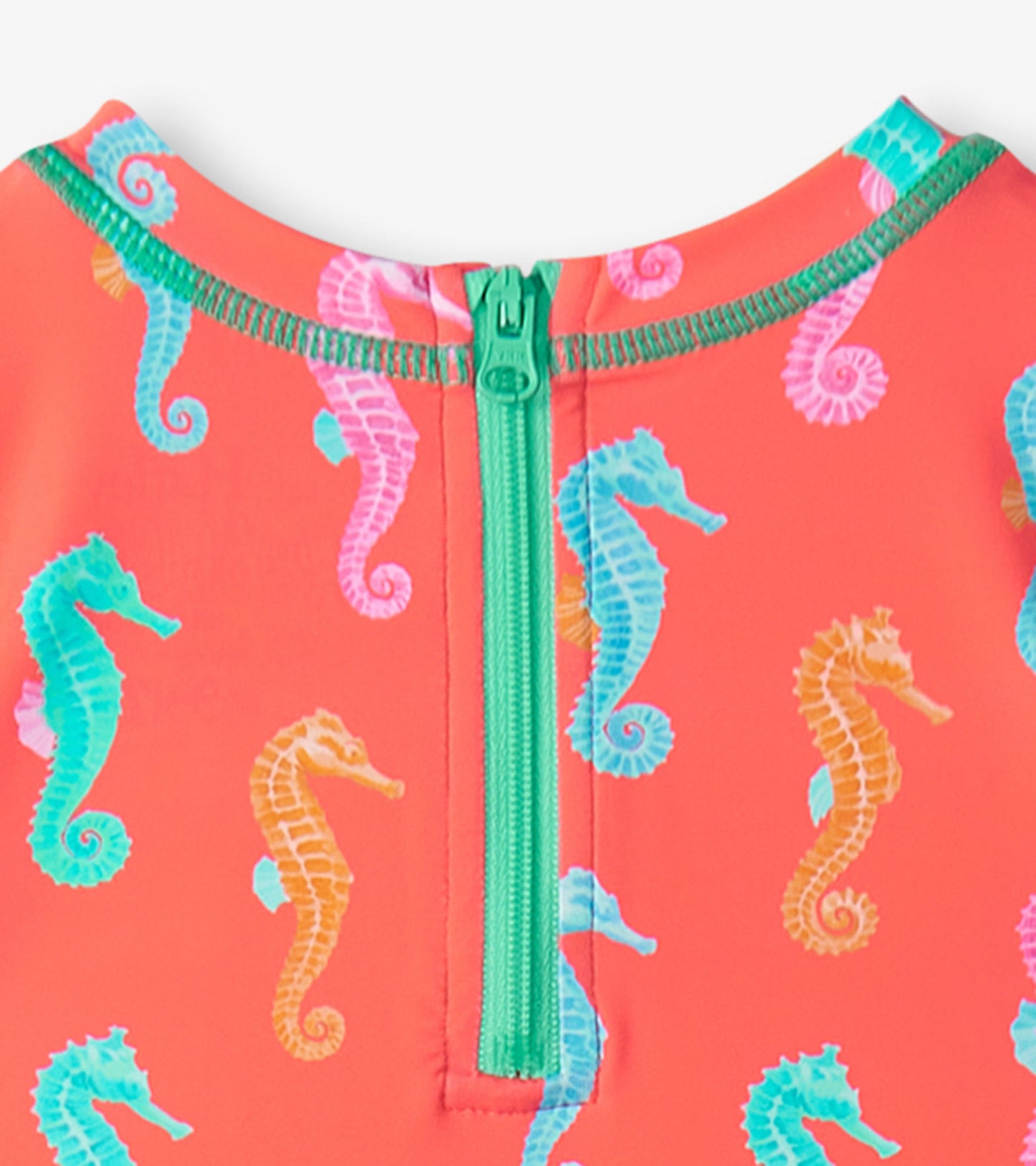 Coral rashguard swimsuit featuring colorful seahorse patterns and a green zipper at the back. Suitable for baby girls.