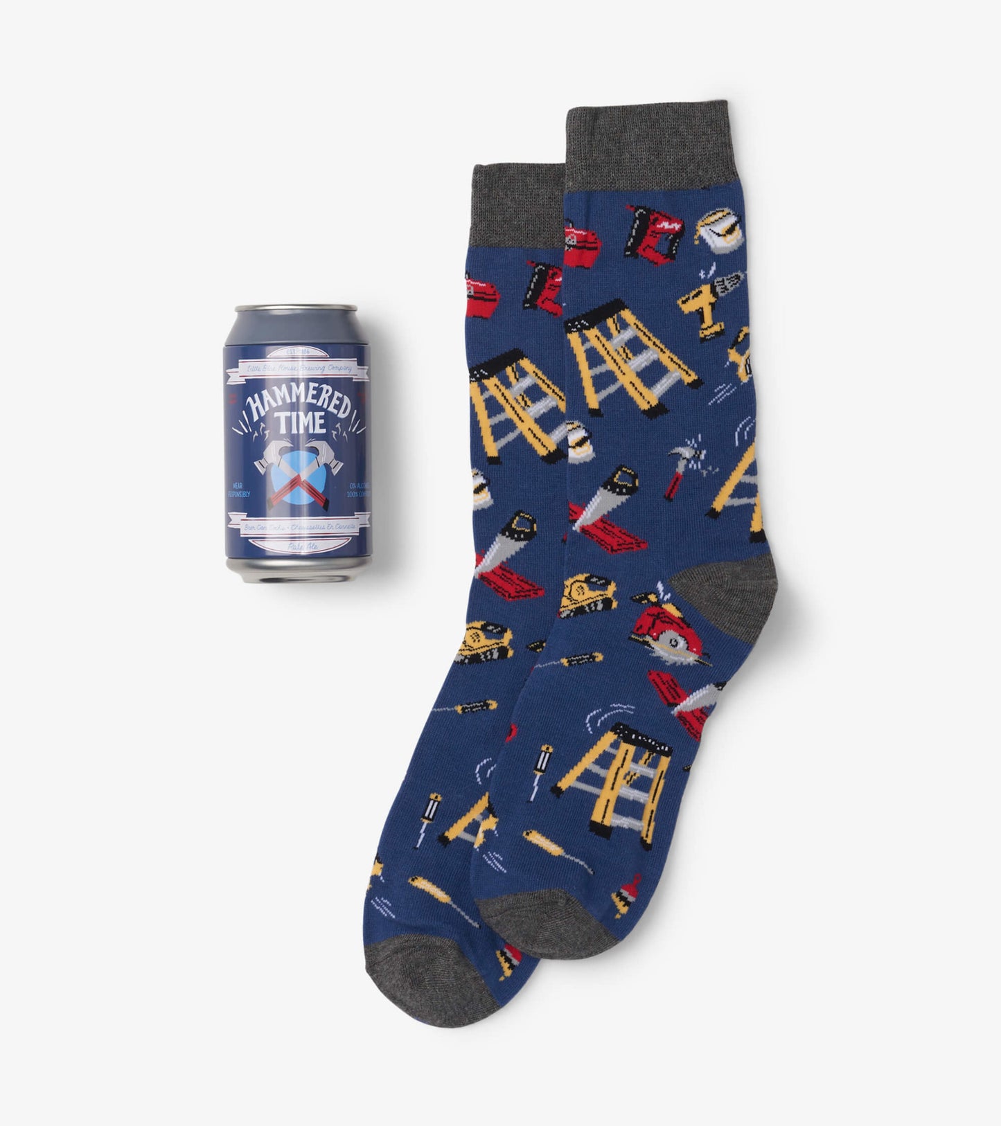 Navy blue socks featuring a fun pattern of tools and equipment, paired with a beer can for scale.