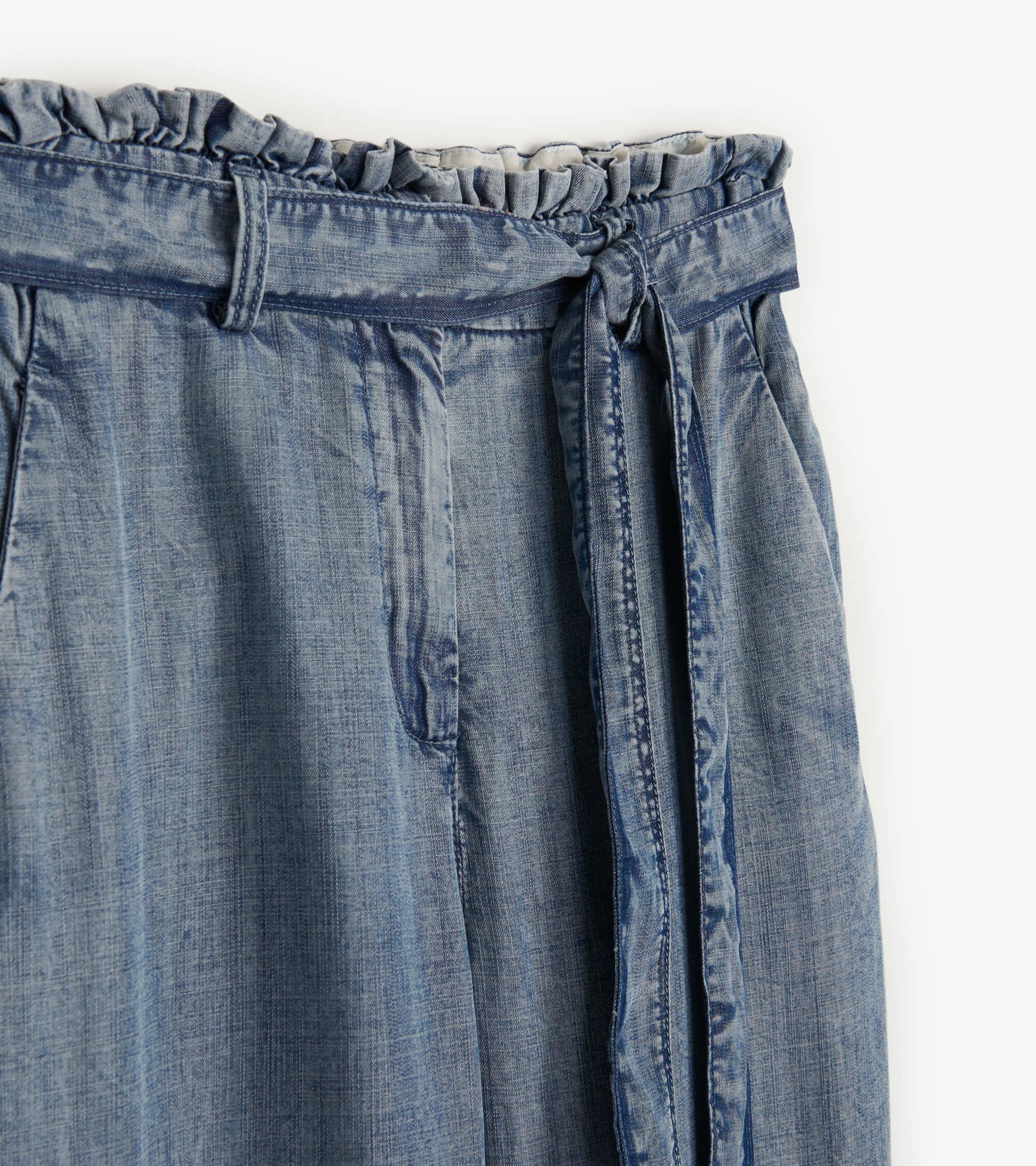 Blue acid rinse paper bag pants with a gathered waistband and tie detail.
